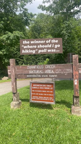 photo of sign to entrance of "dunnfield creek natural area" captioned "the winner of the where should i go hiking poll was"